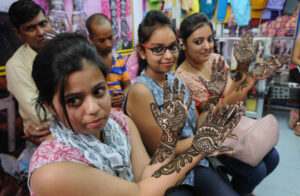 Girls show designs of mehndi on their palms ahead of Karva Chauth in on  Monday.Tribune Photo:Inderjeet Singh